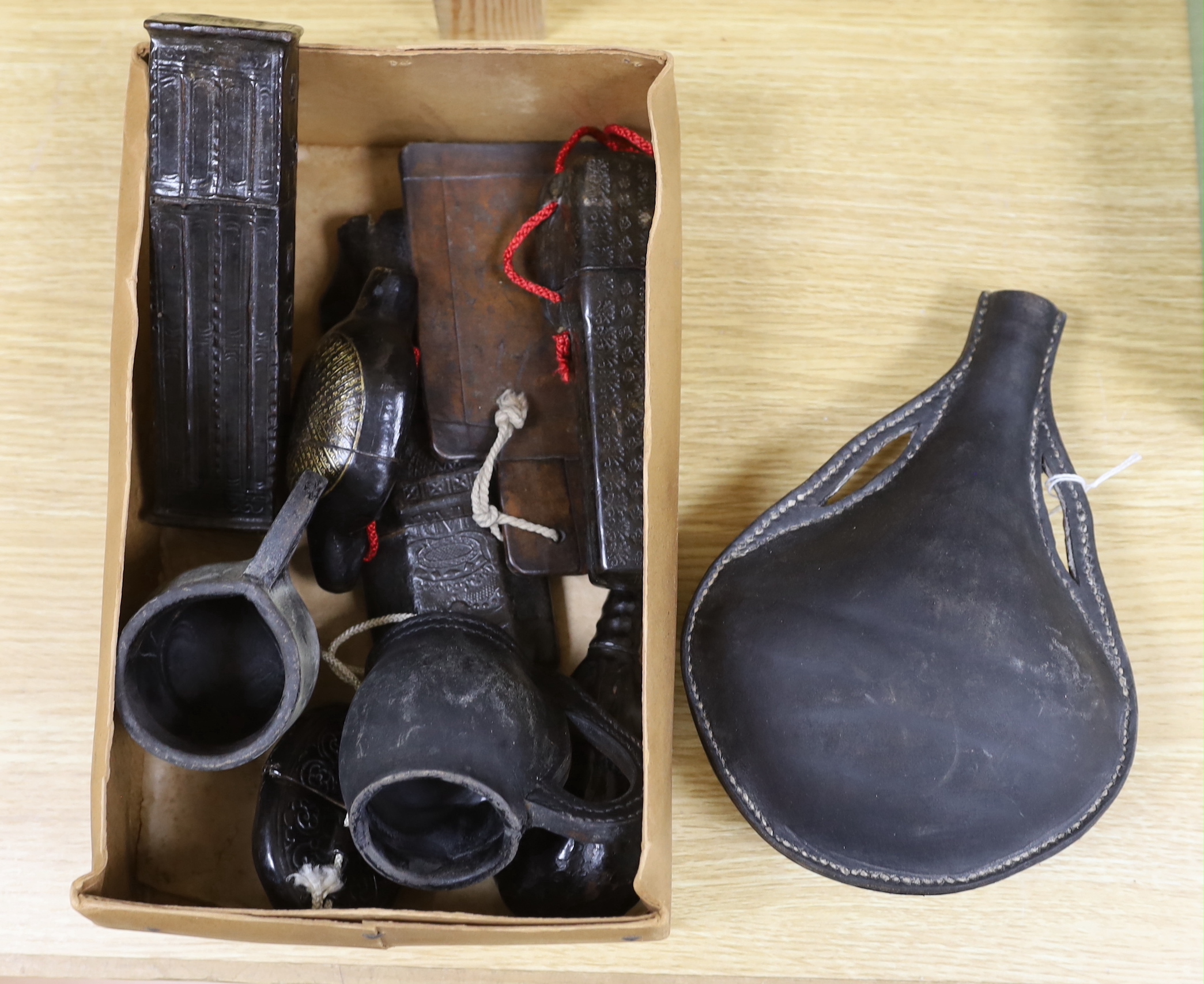 A quantity of stamped leather items including two flasks, two small tankards etc, largest flask 25cm high
